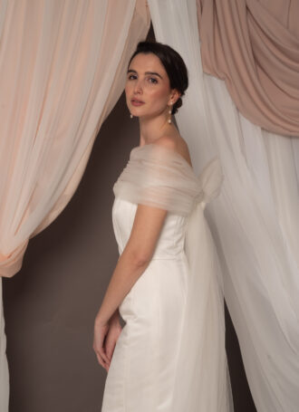 Abito da sposa modello Bustier in duchesse di seta con spacco, bustier dritto e stola in tulle drappeggiato sulle spalle, stile elegante e moderno